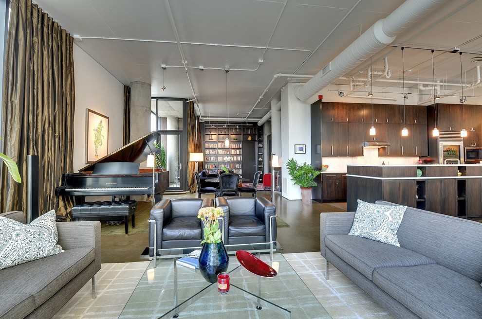 This is an example of a modern open concept living room in Minneapolis with a music area and concrete floors.