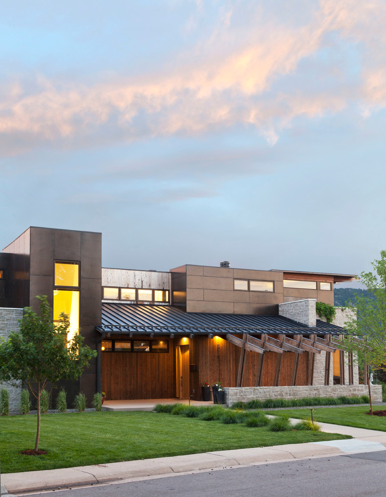 Photo of a contemporary two-storey exterior in Denver with stone veneer and a flat roof.