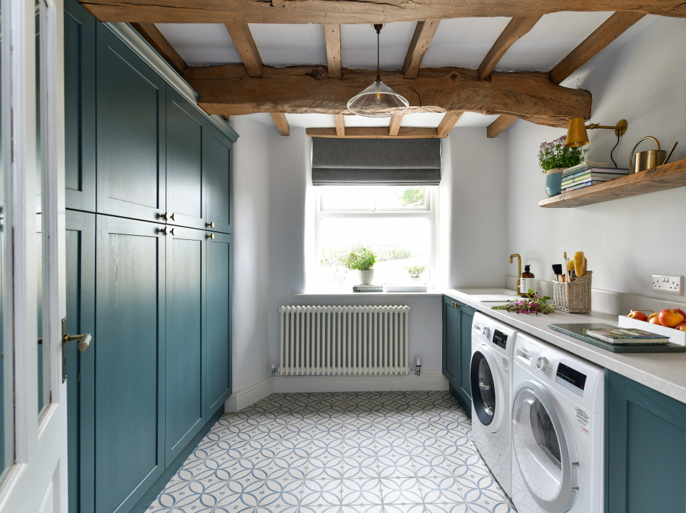 Inspiration for a country galley laundry room in Other with an undermount sink, shaker cabinets, turquoise cabinets, white walls, a side-by-side washer and dryer, multi-coloured floor, grey benchtop and exposed beam.