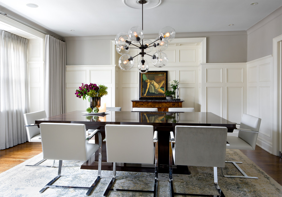 This is an example of a transitional separate dining room in Toronto with grey walls and medium hardwood floors.