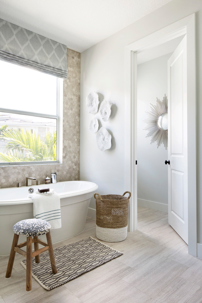 Inspiration for a transitional master bathroom in Miami with a freestanding tub, multi-coloured walls, beige floor and beige tile.