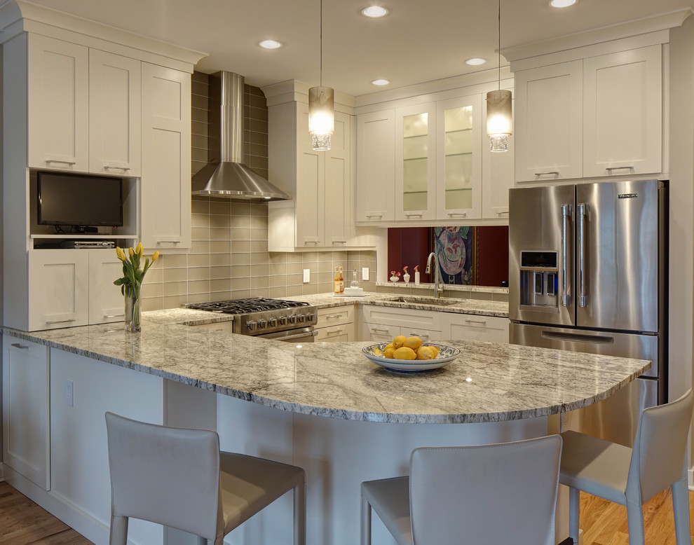 Design ideas for a small transitional u-shaped open plan kitchen in Chicago with a single-bowl sink, shaker cabinets, white cabinets, granite benchtops, glass tile splashback, stainless steel appliances, light hardwood floors, a peninsula and grey benchtop.
