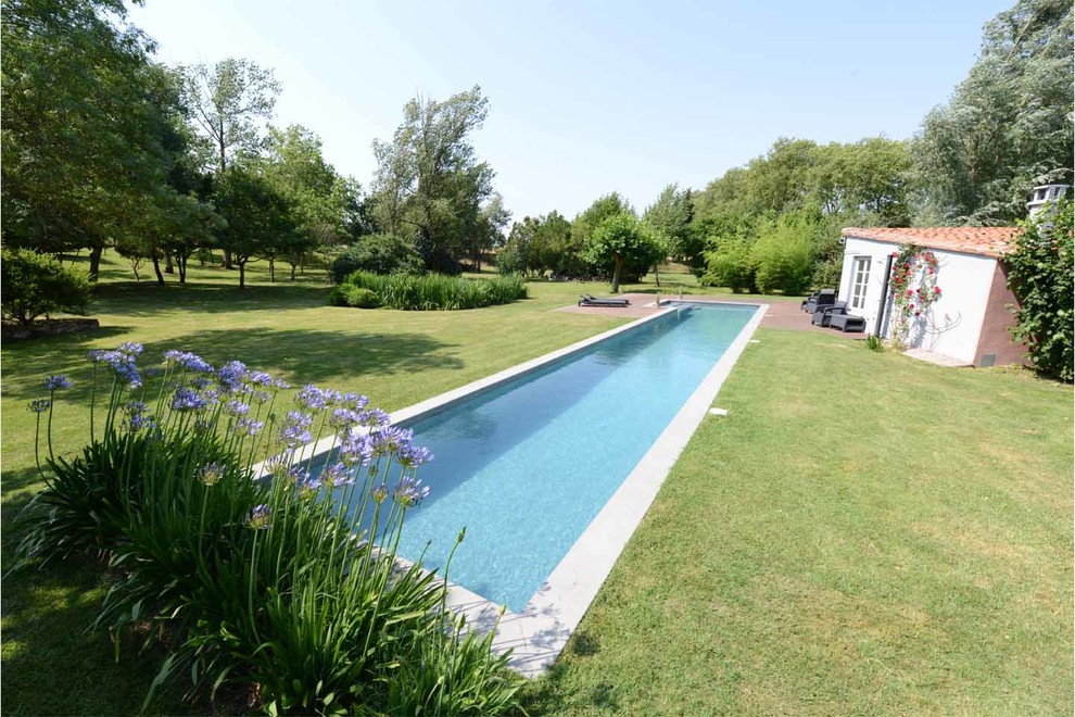 Photo of a large contemporary lap pool in Toulouse with decking.