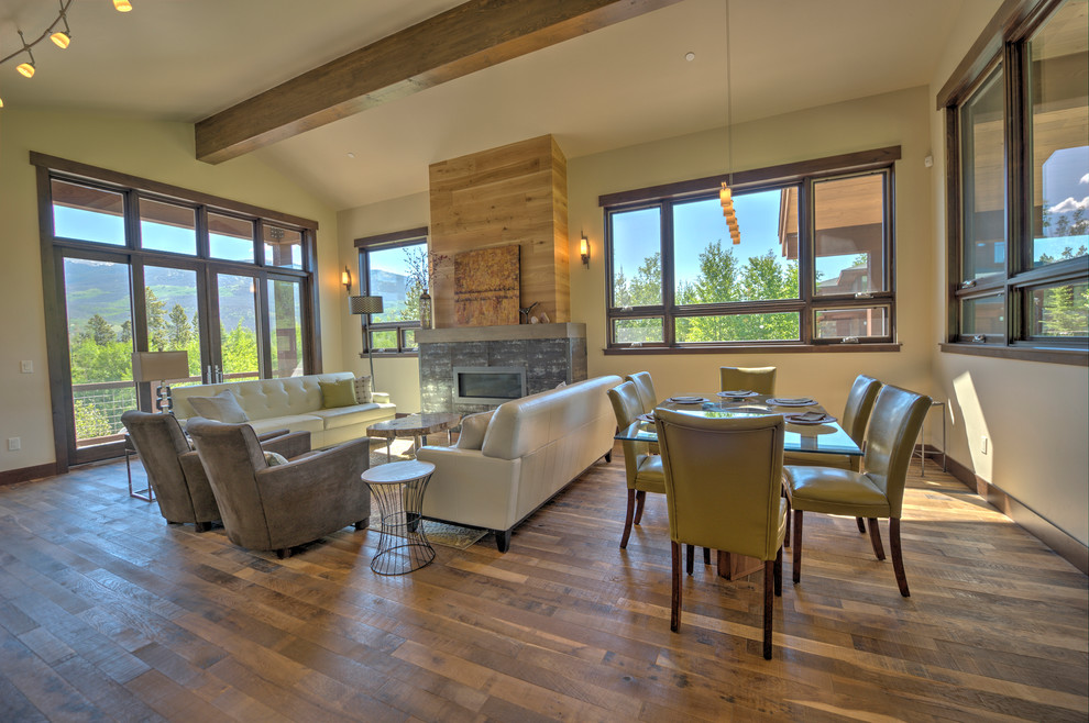 This is an example of a large contemporary formal open concept living room in Denver with medium hardwood floors, a ribbon fireplace and a tile fireplace surround.