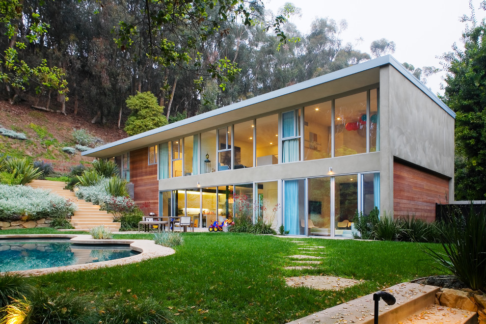 This is an example of a midcentury two-storey grey exterior in Los Angeles with mixed siding and a flat roof.