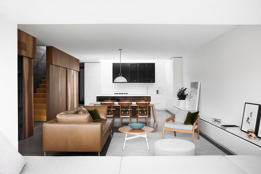 Inspiration for a small modern open concept living room in Melbourne with white walls, concrete floors, no fireplace, no tv and grey floor.