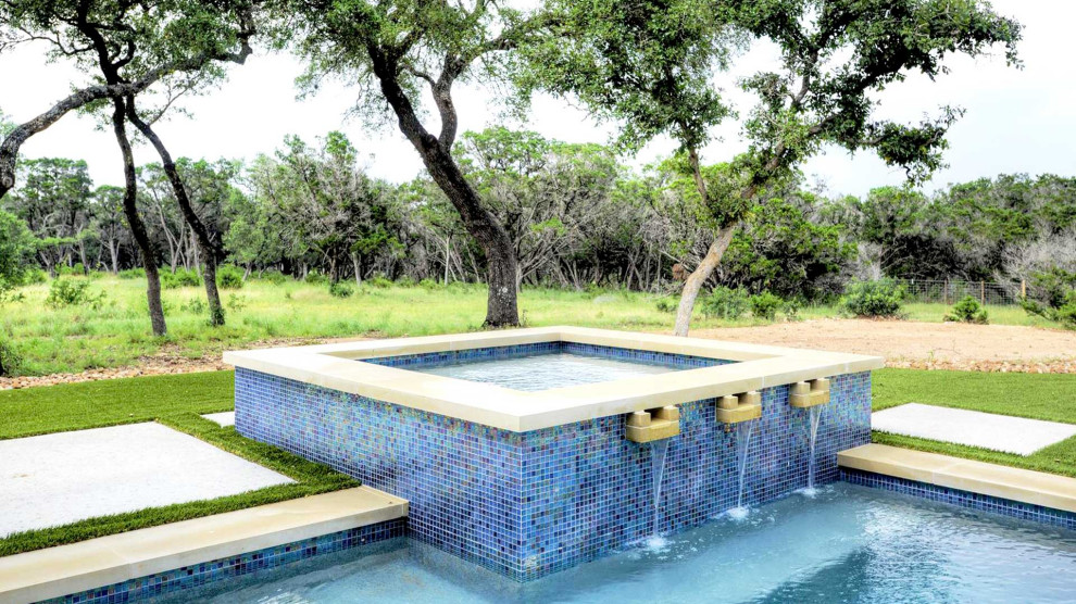 Photo of a large modern courtyard rectangular pool in Austin with concrete slab.