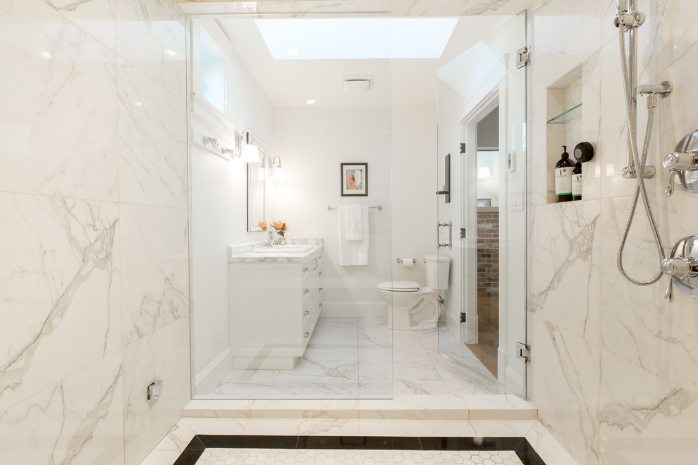 Large traditional master bathroom in Vancouver with recessed-panel cabinets, white cabinets, an alcove shower, marble, white walls, marble floors, a drop-in sink, marble benchtops, a hinged shower door, a two-piece toilet, white tile, white floor and white benchtops.