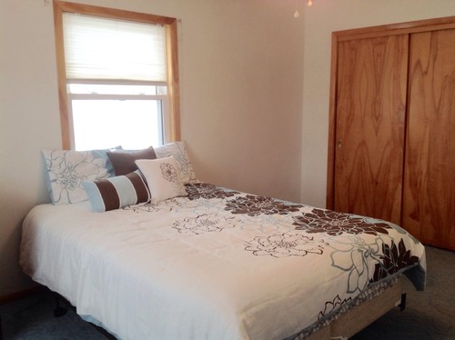 Queen bed in front of window  headboard? Drapes?