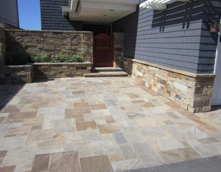 Photo of a mid-sized traditional front yard patio in Phoenix with natural stone pavers and a roof extension.