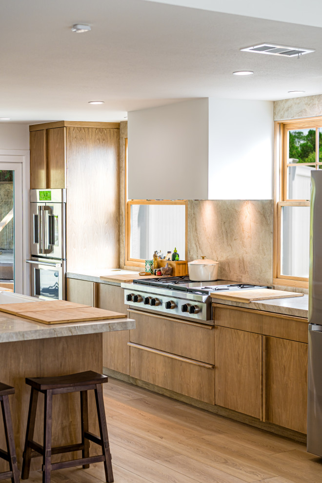 Photo of a contemporary galley eat-in kitchen in Orange County with a drop-in sink, flat-panel cabinets, brown cabinets, marble benchtops, beige splashback, marble splashback, coloured appliances, light hardwood floors, with island, brown floor, grey benchtop and exposed beam.