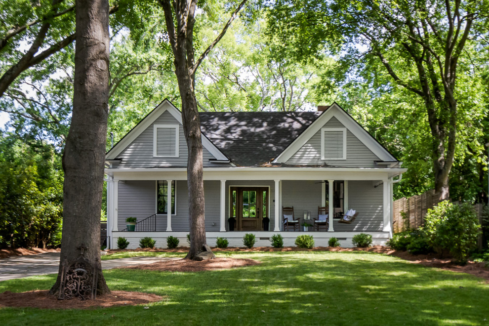 Medium sized and gey farmhouse bungalow detached house in Atlanta with mixed cladding, a shingle roof, a black roof and shiplap cladding.