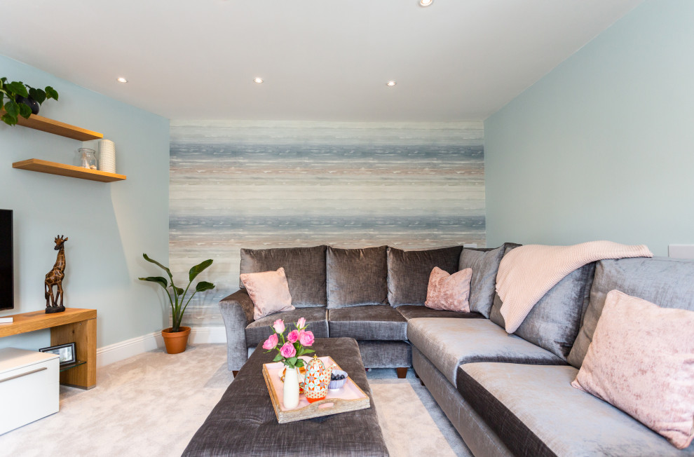 Photo of a large victorian enclosed living room in Other with blue walls, carpet, no fireplace, a freestanding tv and grey floors.