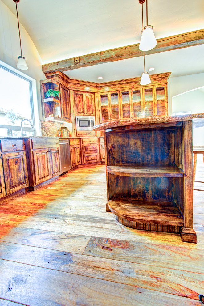 Kitchen pantry - large rustic u-shaped medium tone wood floor kitchen pantry idea with a drop-in sink, glass-front cabinets, medium tone wood cabinets, beige backsplash, stainless steel appliances and an island