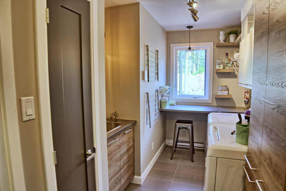 Design ideas for a mid-sized contemporary u-shaped dedicated laundry room in Other with an undermount sink, louvered cabinets, quartzite benchtops, beige walls, ceramic floors, a side-by-side washer and dryer and medium wood cabinets.