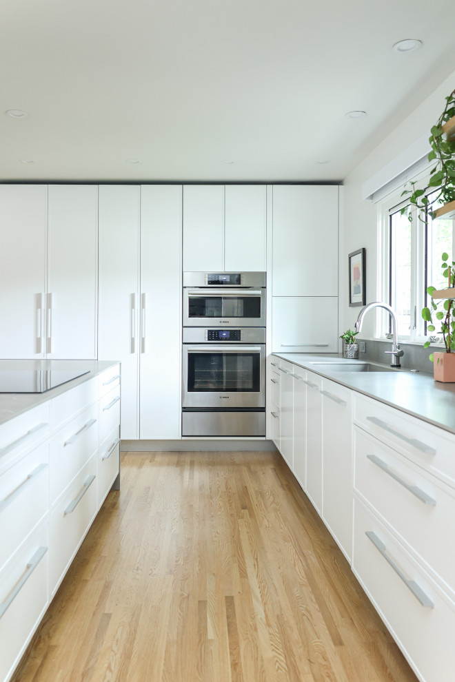 Transitional kitchen photo with an island and white countertops