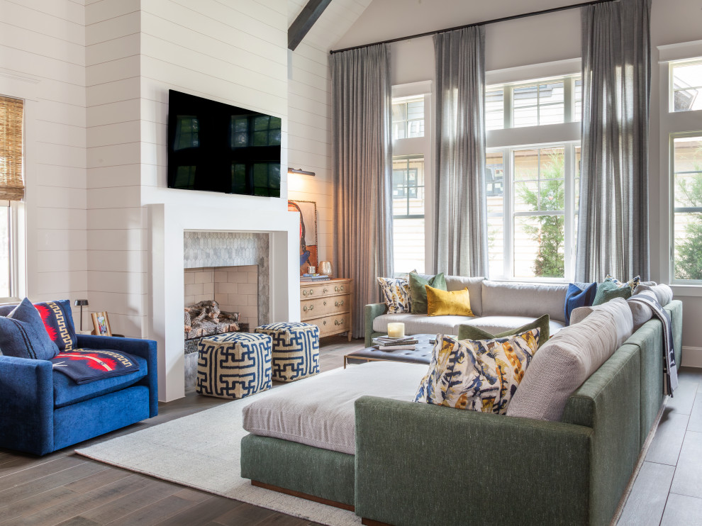 Design ideas for a mid-sized transitional open concept living room in Houston with beige walls, a standard fireplace, a wall-mounted tv, brown floor, exposed beam, planked wall panelling, porcelain floors and a wood fireplace surround.