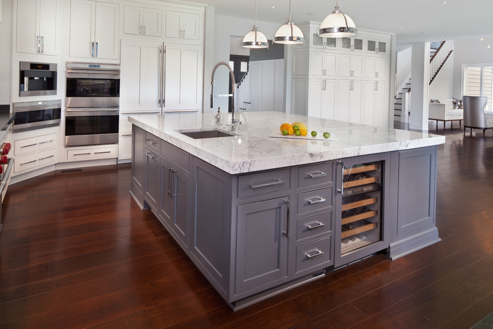 Inspiration for a transitional u-shaped eat-in kitchen in DC Metro with an undermount sink, white cabinets, panelled appliances and beaded inset cabinets.