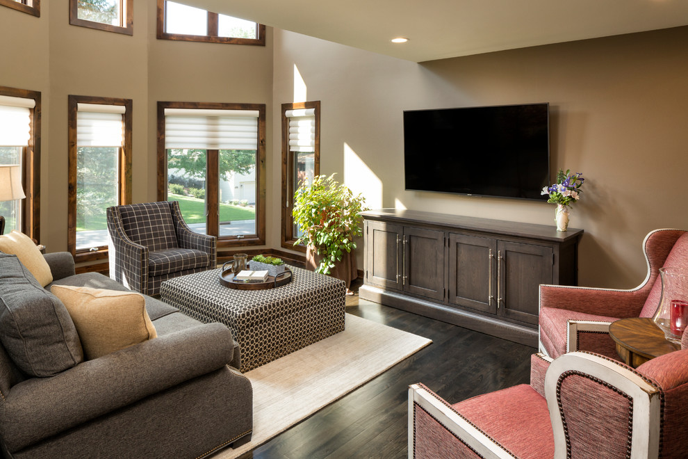This is an example of a mid-sized traditional formal open concept living room in Minneapolis with beige walls, dark hardwood floors, no fireplace, a wall-mounted tv and brown floor.