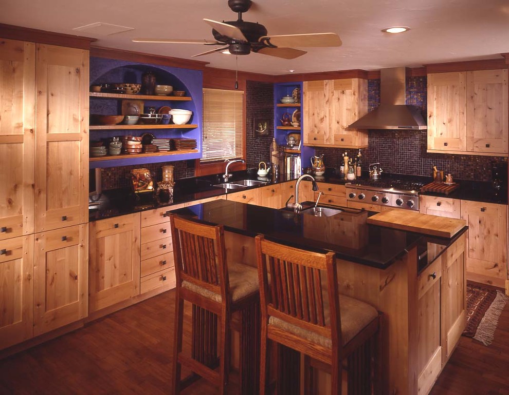 Photo of a mid-sized arts and crafts l-shaped separate kitchen in Wichita with an undermount sink, stainless steel appliances, dark hardwood floors, with island, metallic splashback, glass tile splashback, shaker cabinets, medium wood cabinets, quartz benchtops and brown floor.
