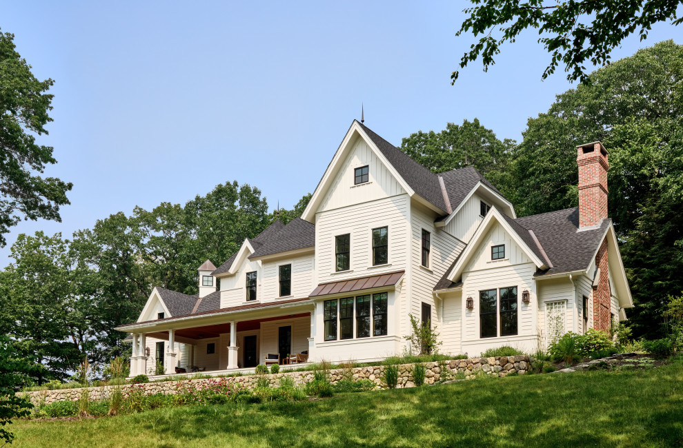 Mid-sized cottage white house exterior photo in Boston with a shingle roof and a black roof
