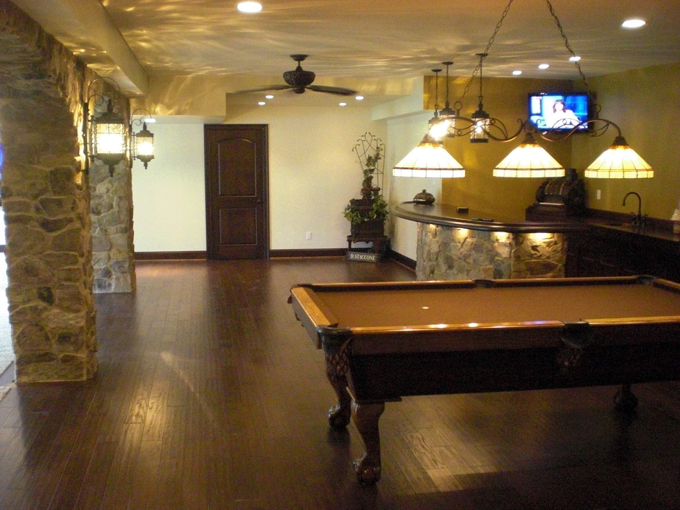 Inspiration for a large traditional look-out basement in Philadelphia with beige walls, dark hardwood floors and multi-coloured floor.