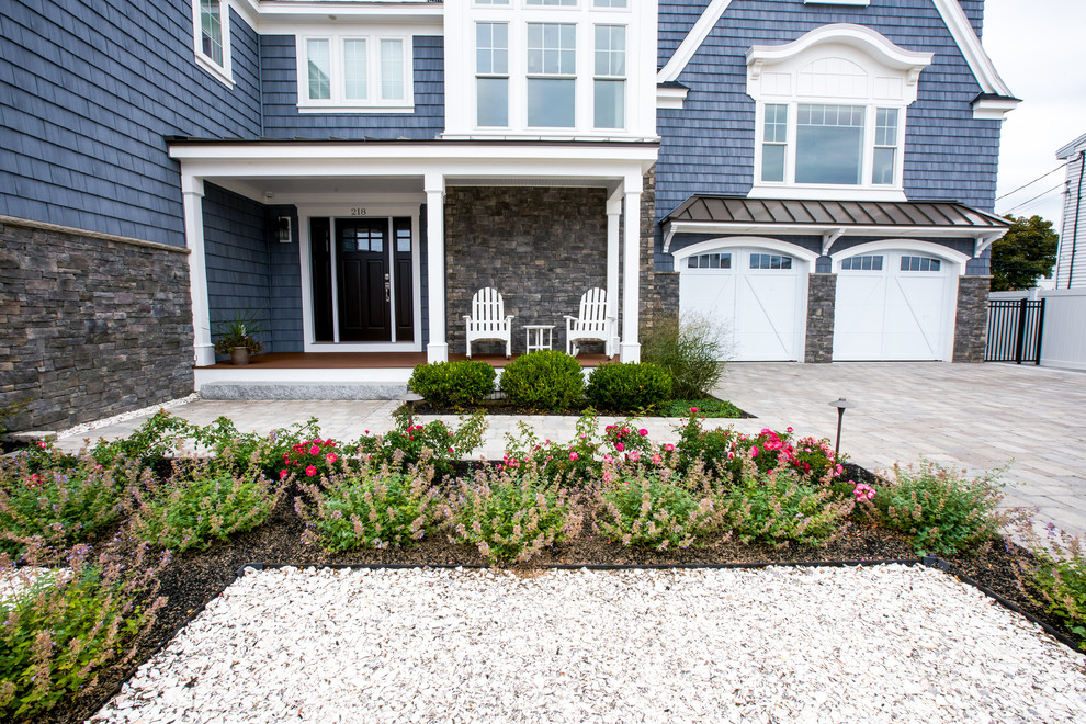 Design ideas for a mid-sized beach style front yard garden in Boston with natural stone pavers.