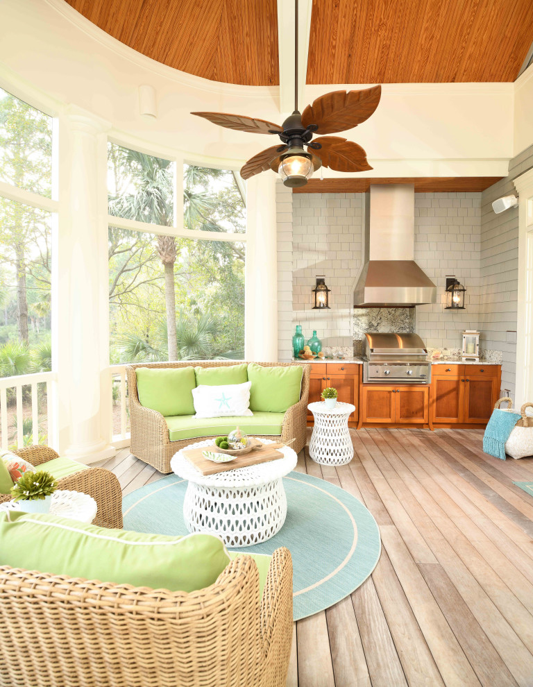 Beach style screened-in and wood railing porch photo in Charleston with decking and a roof extension
