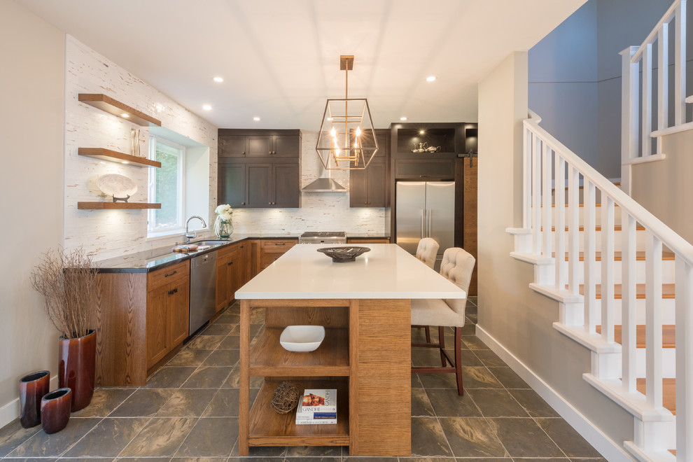 Large transitional slate floor and multicolored floor kitchen pantry photo in Vancouver with an undermount sink, shaker cabinets, dark wood cabinets, quartz countertops, white backsplash, porcelain backsplash, stainless steel appliances, an island and white countertops