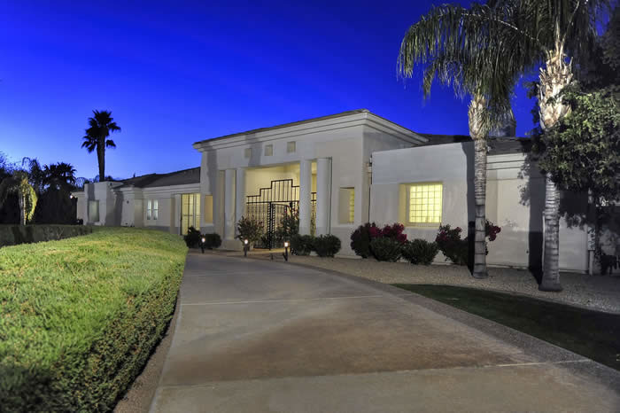 Example of a huge transitional concrete floor front door design in Phoenix with beige walls and a glass front door