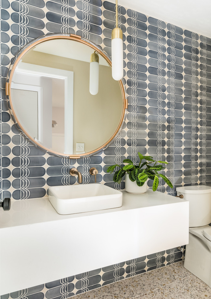 This is an example of a mid-sized contemporary powder room in Nashville with open cabinets, white cabinets, blue tile, porcelain tile, beige walls, terrazzo floors, a vessel sink, engineered quartz benchtops, white floor, white benchtops and a floating vanity.
