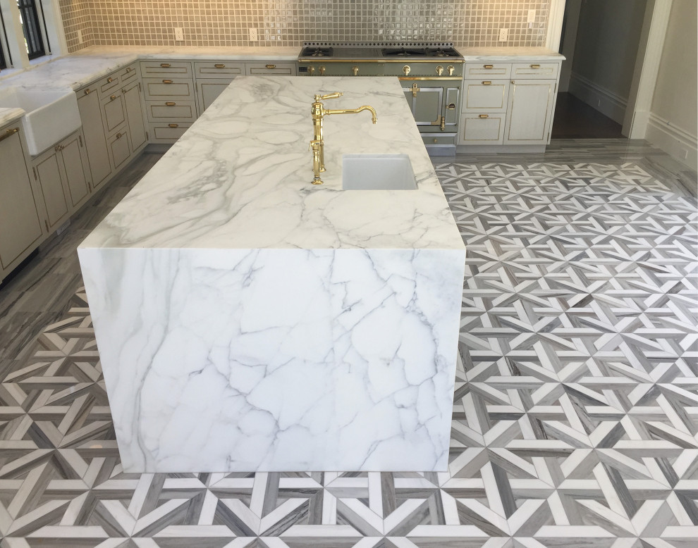 Example of a large l-shaped marble floor, multicolored floor and coffered ceiling kitchen design in San Francisco with an undermount sink, white cabinets, marble countertops, beige backsplash, ceramic backsplash, colored appliances, an island and white countertops