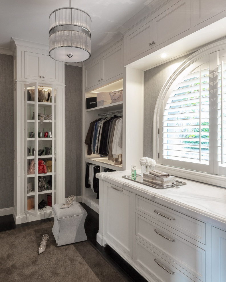 Inspiration for a transitional women's walk-in wardrobe in San Francisco with beaded inset cabinets, white cabinets, carpet and grey floor.