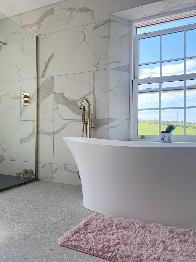 Inspiration for a mid-sized contemporary master bathroom in Belfast with shaker cabinets, a freestanding tub, an open shower, a two-piece toilet, white tile, marble, white walls, terrazzo floors, a vessel sink, quartzite benchtops, grey floor, an open shower, white benchtops, a single vanity and a freestanding vanity.