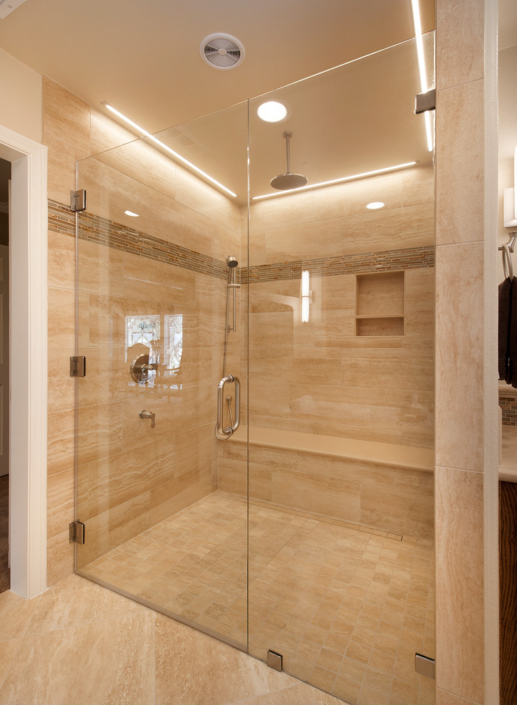 Design ideas for a large traditional master bathroom in Orange County with raised-panel cabinets, dark wood cabinets, a curbless shower, a one-piece toilet, beige tile, glass tile, beige walls, travertine floors, an undermount sink and engineered quartz benchtops.