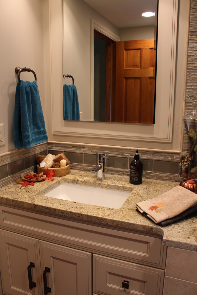 Inspiration for a small transitional 3/4 brown tile and matchstick tile corner shower remodel in Chicago with furniture-like cabinets, white cabinets, a one-piece toilet, an undermount sink and granite countertops