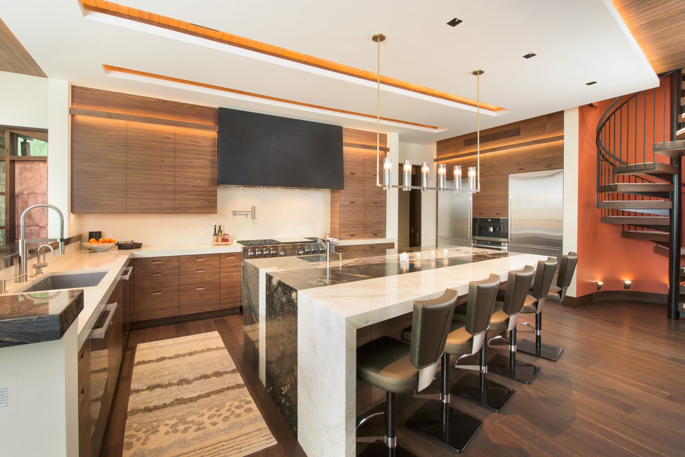 Inspiration for an expansive contemporary l-shaped kitchen in Denver with flat-panel cabinets, medium wood cabinets, marble benchtops, beige splashback, stainless steel appliances, medium hardwood floors, with island and an undermount sink.