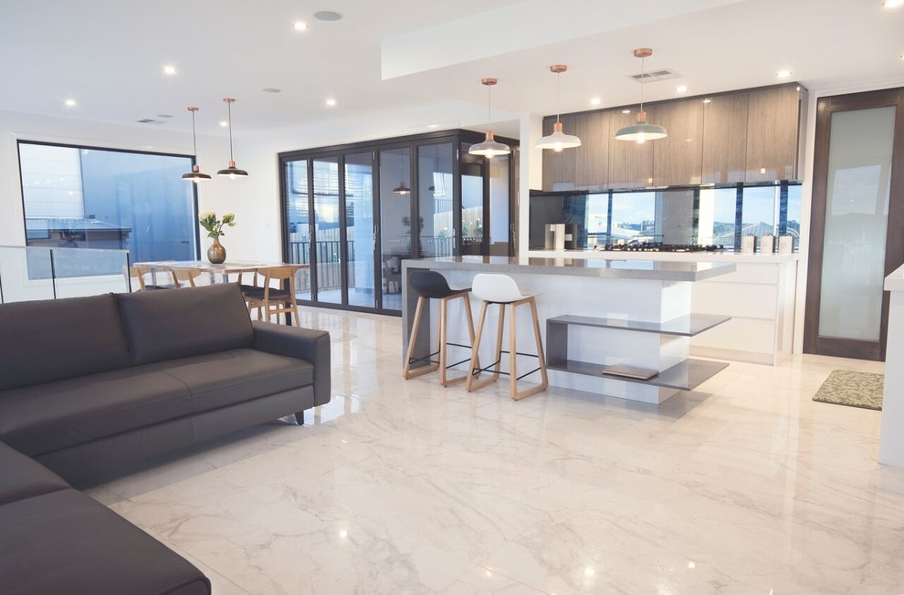 Design ideas for a small contemporary l-shaped open plan kitchen in Canberra - Queanbeyan with flat-panel cabinets, granite benchtops, metallic splashback, mirror splashback, marble floors, with island and white floor.