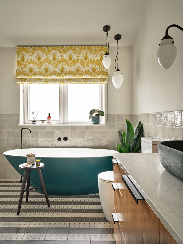 This is an example of an eclectic grey and yellow bathroom in Hampshire.