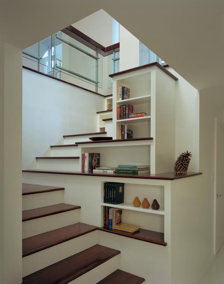 This is an example of a mid-sized transitional wood l-shaped staircase in New York with painted wood risers.