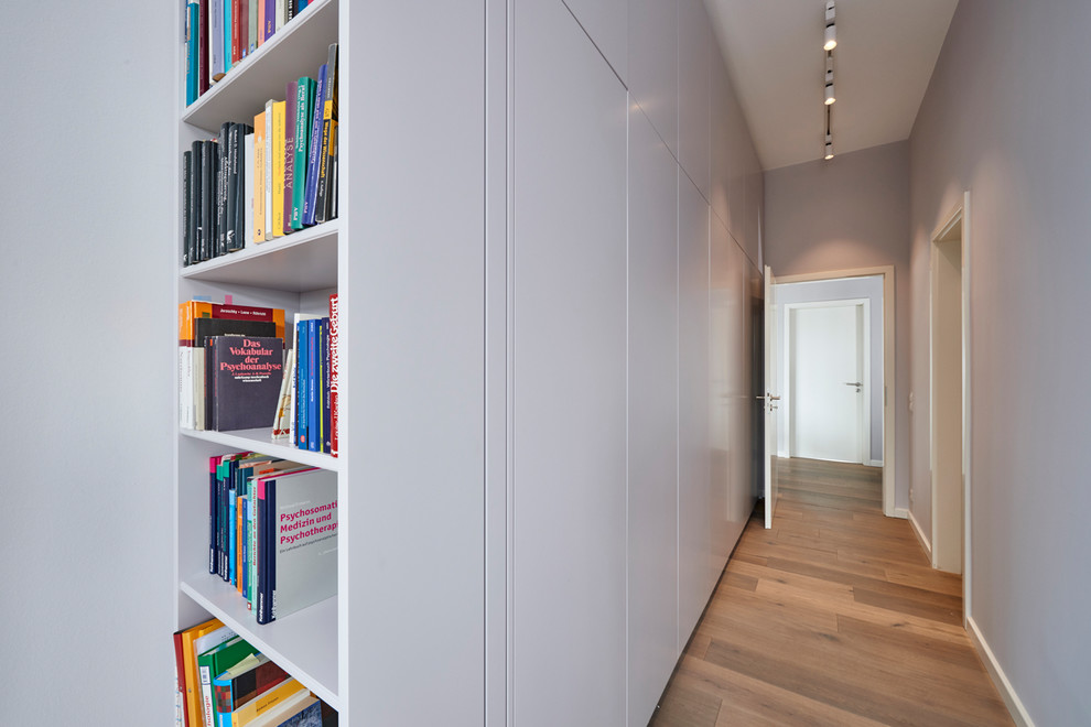 Mittelgroßer Moderner Flur mit grauer Wandfarbe, braunem Holzboden und braunem Boden in Hamburg