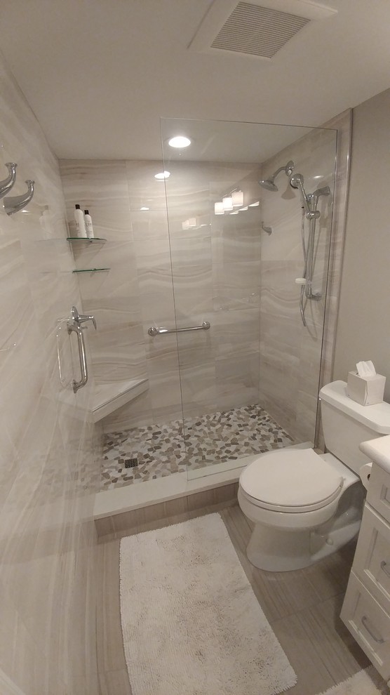 Mid-sized beach style master bathroom in Tampa with shaker cabinets, white cabinets, an alcove shower, a two-piece toilet, beige tile, porcelain tile, beige walls, porcelain floors, a drop-in sink, engineered quartz benchtops, beige floor and an open shower.