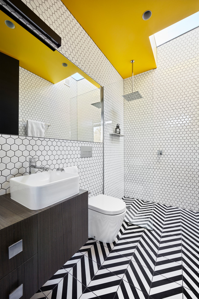 Inspiration for a contemporary 3/4 bathroom in Melbourne with flat-panel cabinets, dark wood cabinets, a curbless shower, a wall-mount toilet, porcelain tile, white walls, a vessel sink, wood benchtops, multi-coloured floor and an open shower.