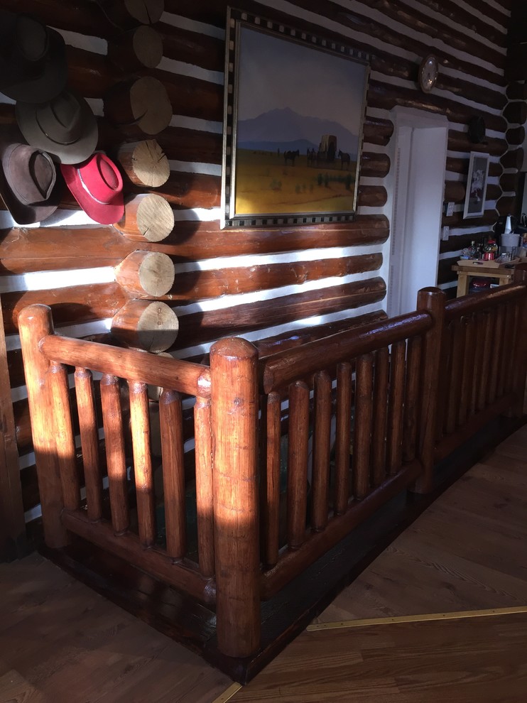 Inspiration for a mid-sized rustic wooden straight staircase remodel in Denver with wooden risers