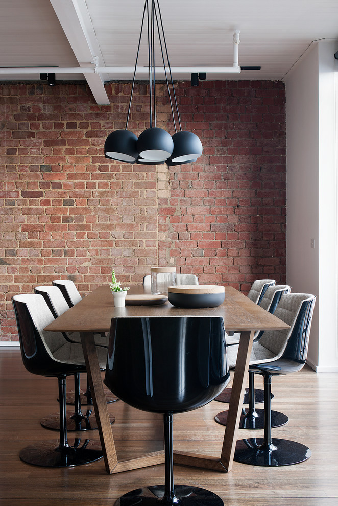 Contemporary dining room in Melbourne with dark hardwood floors.