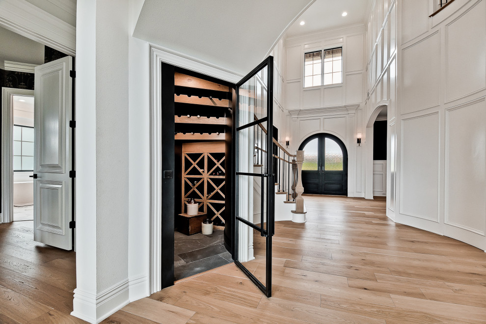 Inspiration for a small transitional wine cellar in Other with porcelain floors, storage racks and black floor.