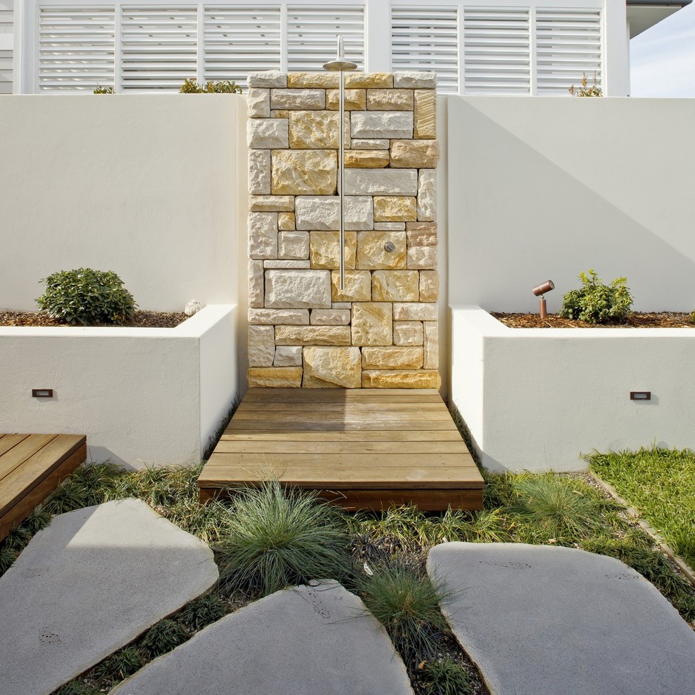 Design ideas for a large contemporary backyard full sun outdoor sport court for summer in Sydney with natural stone pavers.