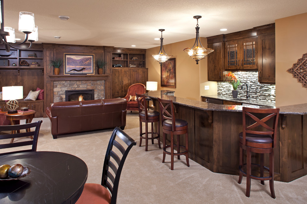Design ideas for a mid-sized traditional u-shaped seated home bar in Minneapolis with an undermount sink, shaker cabinets, medium wood cabinets, granite benchtops, multi-coloured splashback, matchstick tile splashback, carpet and beige floor.