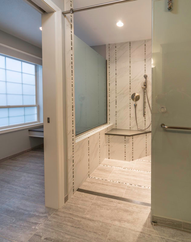 Photo of a large traditional master bathroom in Seattle with raised-panel cabinets, white cabinets, a curbless shower, a two-piece toilet, black and white tile, porcelain tile, grey walls, porcelain floors, quartzite benchtops and an undermount sink.