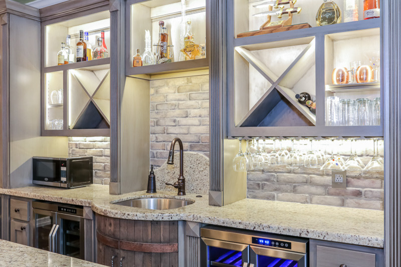 Photo of a small eclectic single-wall open plan kitchen in Houston with an undermount sink, open cabinets, distressed cabinets, granite benchtops, grey splashback, stone tile splashback, stainless steel appliances, medium hardwood floors and with island.